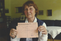 Ingrid Von Oelhafen holding the first official document of her existence, a vaccination certificate issued by Lebensborn

