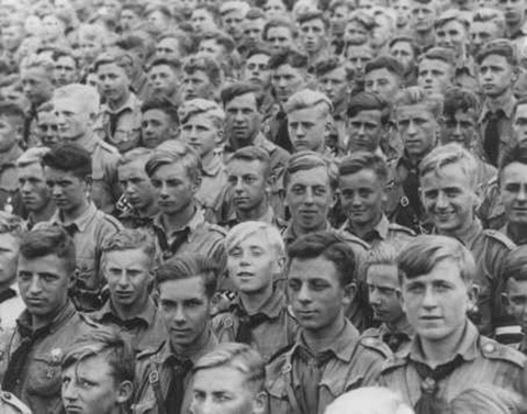 Hitler Youth members listen to a speech by Adolf Hitler at a Nazi „party day“ rally. Nuremberg, Germany, September 11, 1935 (World Wide Photo)