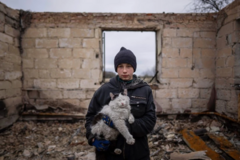Danyk Rak, 12, holds a cat standing on the debris of his house destroyed by Russian forces’ shelling in the outskirts of Chernihiv, Ukraine, Wednesday, April 13, 2022. After the shelling, Danyk’s mother, Liudmila Koval, had to have her leg amputated and was injured in her abdominal cavity. She is still waiting for proper medical treatment. (AP Photo/Evgeniy Maloletka)